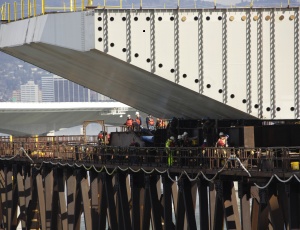 The first permanent deck section of the San Francisco-Oakland Bay Bridge�s Self-Anchored Suspension Span was hoisted this week onto the bridge�s temporary support steel.