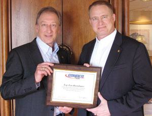 G. Bennett Closner (left) of Closner Equipment accepts award from Kent Godbersen, GOMACO vice president of Worldwide Sales & Marketing.