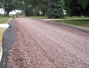 Finished street has open pores and no crown. Gravel and sand base ensures drainage.