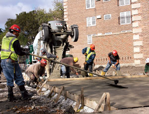 Workers pour a concrete driveway for Chicago’s $28.2-million Dearborn Homes stimulus project.