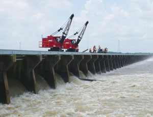 Sandbag rings (above) keep levees from eroding from within. Control structures like the Bonnet Carré Spillway (below) can relieve pressure.