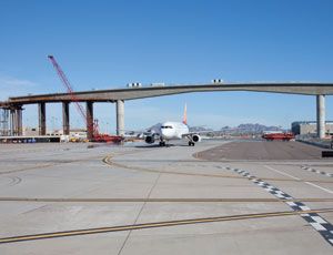 Crews Squeeze Mass Transit Guideway Over Active Taxiway