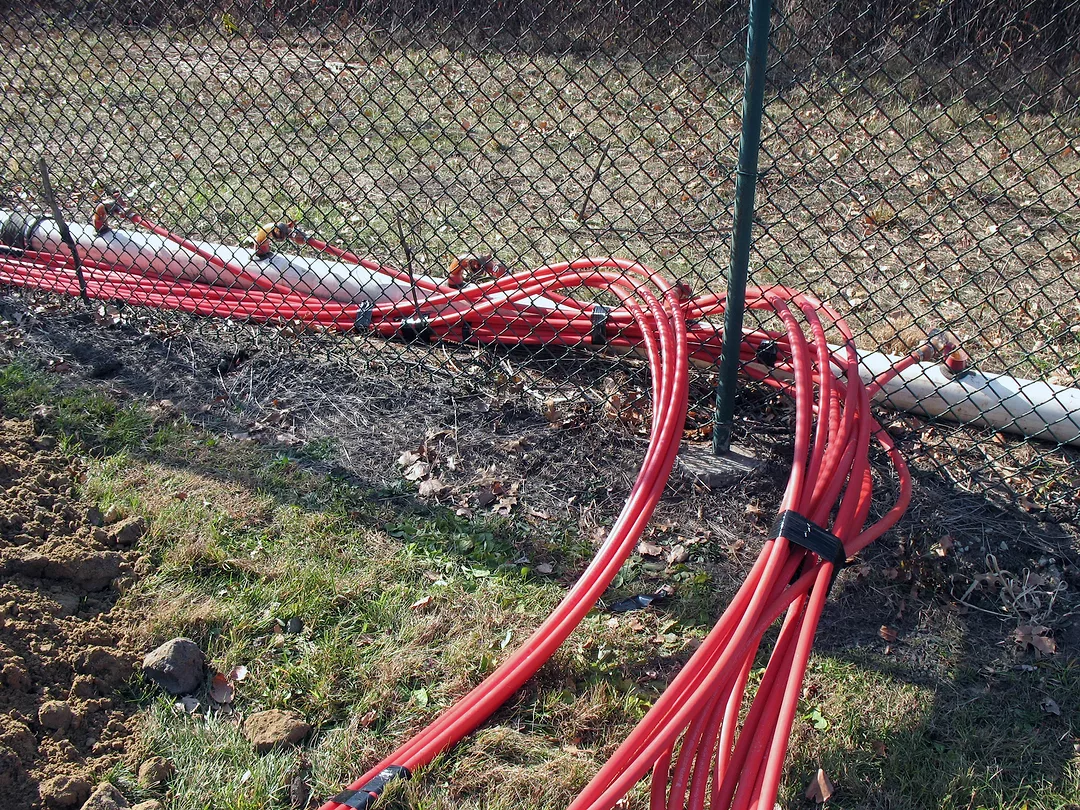 Wickpoints bundled together and ran through a fence and connected to header pipe