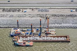 Crane-barge-Titaan-placing-XblocPlus-armour.jpg
