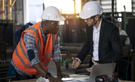 two men in hard hats in discussion