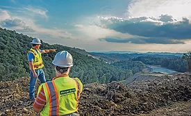 construction workers overlooking the land