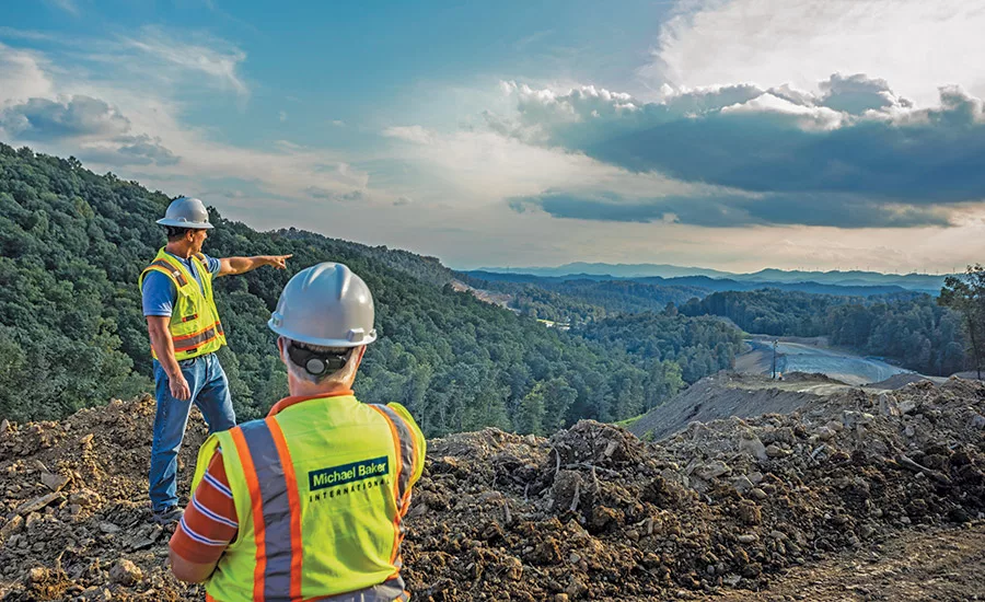 construction workers overlooking the land