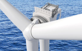 View from above of a white offshore wind turbine with parts of three blades and a GE logo visible. In the background is blue flowing water 