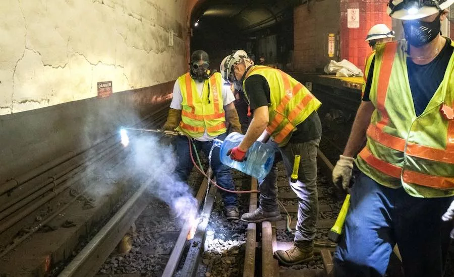 Crews work on the MBTA Blue Line rails