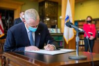 Massachusetts Gov. Charlie Baker signing a landmark climate bill