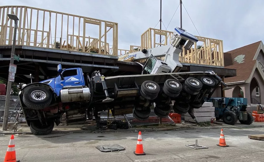 Mobile crane falls onto job site in Boston
