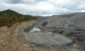 open pit coal mine in Virginia with trees in the horizon