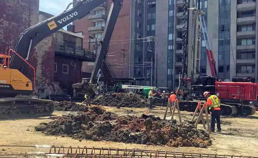 An excavator digs on a project site
