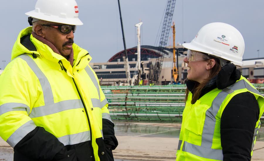 Charles Davis, Superintendent of Waller Corp., talks with another worker on the site of Pittsburgh International Airport’s modernization program. 