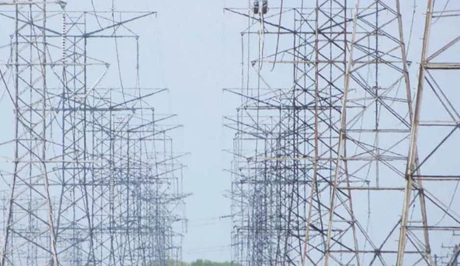 Two rows of transmission towers are shown against a blue sky