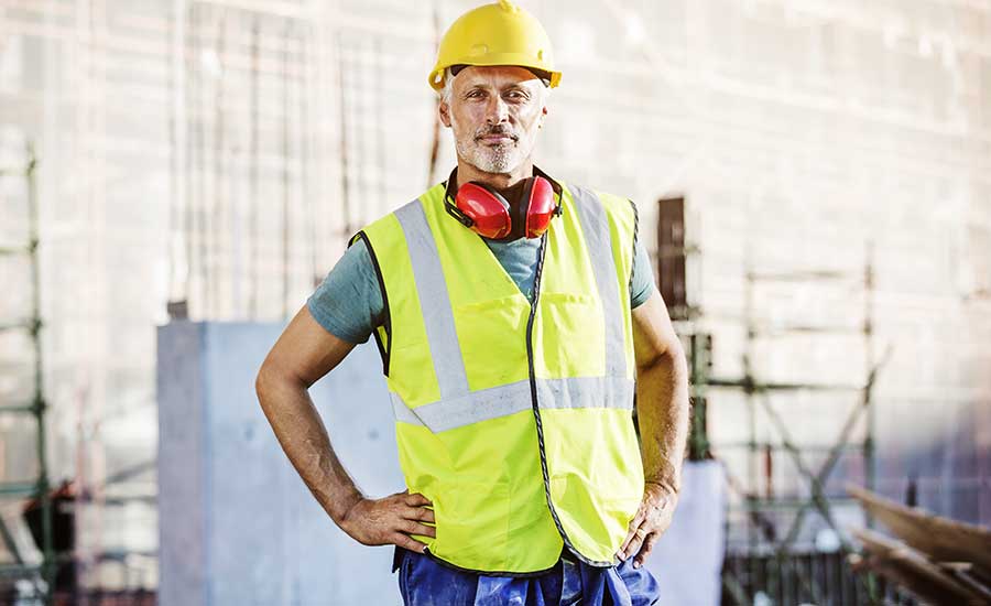 man in reflective vest and hard hat