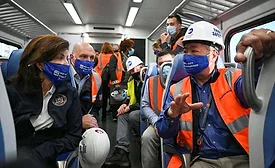 New York Governor Kathy Hochul listens to LIRR president Phillip Eng on an LIRR train from Jamaica to Grand Central Terminal in Manhattan