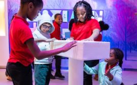 Kids engage with an exhibit at the National Building Museum about construction