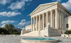 Photo shows steps and facade of the Supreme Court with a fountain in front