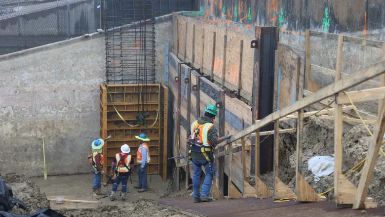 construction workers place rebar framework for fronting protection on a pumping station in Port Arthur, Texas