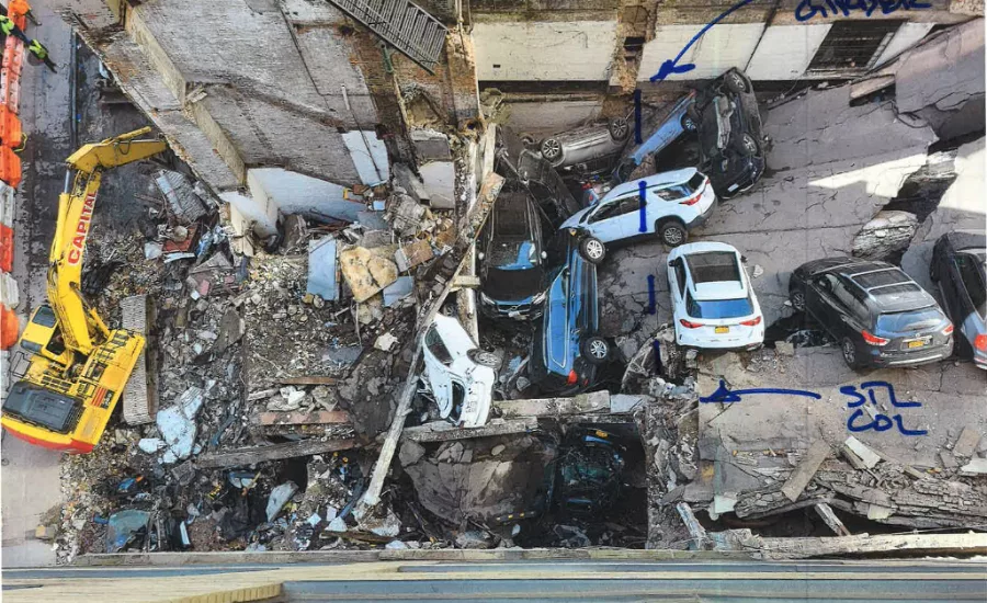 debris and cars are seen from above in the remains of a partially collapsed parking structure