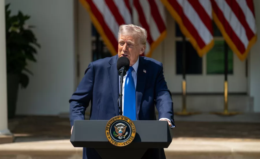 President Donald Trump speaks at a podium in the White House rose garden