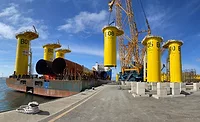 wind turbine equipment is loaded by crane onto a vessel at the South Brooklyn Marine Terminal.jpg