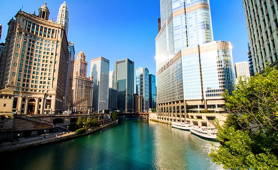 View of the Trump tower and other buildings on either side of the Chicago river in the center of the photo