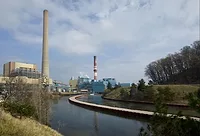 Picture of turbines at a coal plant facility situated along a body of water