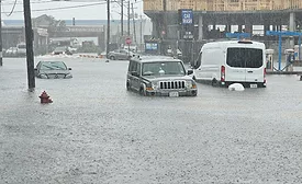 vehicles caught on a flooded road in Massachusetts