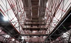 Interior view of the U.S. Air Force Academy Cadet Chapel under restoration, showing extensive scaffolding reaching up to the ceiling as part of the $334.7-million repair project.