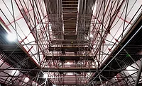Interior view of the U.S. Air Force Academy Cadet Chapel under restoration, showing extensive scaffolding reaching up to the ceiling as part of the $334.7-million repair project.