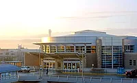 Boise Airport terminal exterior in morning light, highlighting the modern glass entry. Expansion aims to add gates and infrastructure to handle record passenger growth.