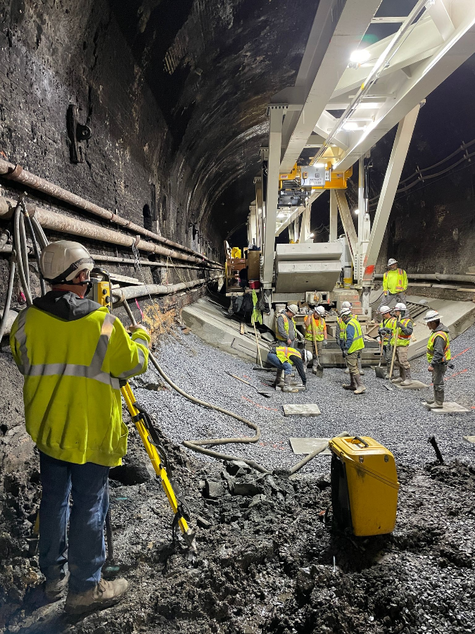 Crews prepare to place a PCIS segment on the subgrade leveling pads