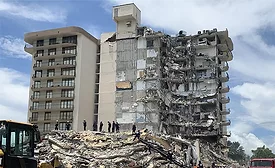 Surfside condo collapse scene showing debris and responders; NIST says failure began in pool deck slab-column connection.
