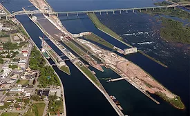 Aerial view of the Soo Locks complex in Sault Ste. Marie, Mich., showing ongoing Phase 3 construction of the New Lock at the Soo, with cranes and work zones visible alongside existing lock chambers.