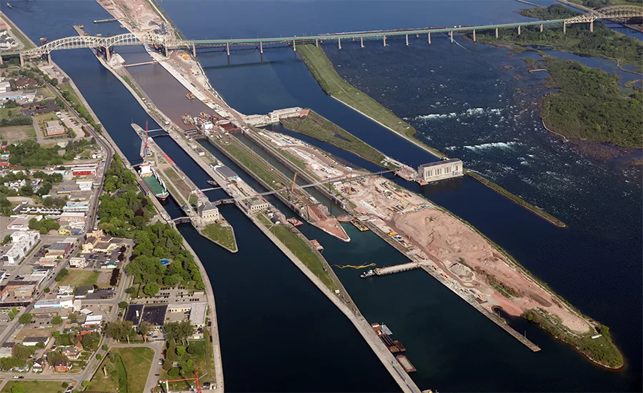 Aerial view of the Soo Locks complex in Sault Ste. Marie, Mich., showing ongoing Phase 3 construction of the New Lock at the Soo, with cranes and work zones visible alongside existing lock chambers.