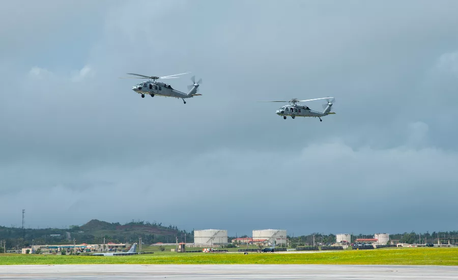 Two MH-60S SeaHawk helicopters are seen flying over Andersen Air Force Base