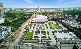 Aerial photo of the Ismaili Center Houston with surrounding gardens and construction along Allen Parkway.