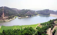 Aerial view of Syphon Reservoir in Irvine, Calif., surrounded by suburban neighborhoods and hills.