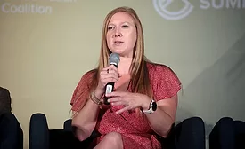 Emily Domenech speaks into a microphone 