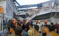 A joint search and rescue team, assisted by heavy equipment, is searching for and rescuing victims trapped in the collapse of an Islamic boarding school in Sidoarjo Regency, East Java, on Monday, Sept. 29.