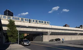 A CTA train is seen crossing above Balmoral Avenue on a new track structure.