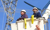 AEPTransimission-Investment_ENRweb.jpg Workers in a cherry picker bucket near transmission lines