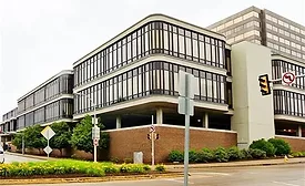 Exterior view of Nova Place in Pittsburgh, a modern mid-rise office complex with rounded glass façades and concrete framing that will become Eos Energy Enterprises’ new headquarters. 