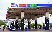 Mich.-Fuel-Tax Marathon gas station canopy with digital fuel price display and multiple fuel dispensers.