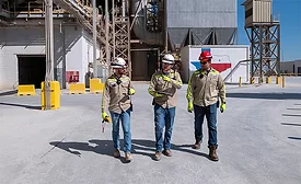 Amrize workers in safety gear walk through the Midlothian, Texas, cement plant during modernization and “Made in America” rollout.
