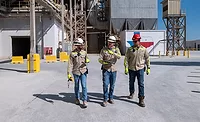 Amrize---Made-in-America Amrize workers in safety gear walk through the Midlothian, Texas, cement plant during modernization and “Made in America” rollout.