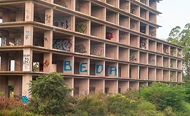Unfinished commercial building with graffiti, illustrating declining commercial construction spending.