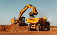 Bedrock autonomous Cat excavator loads a John Deer rock truck